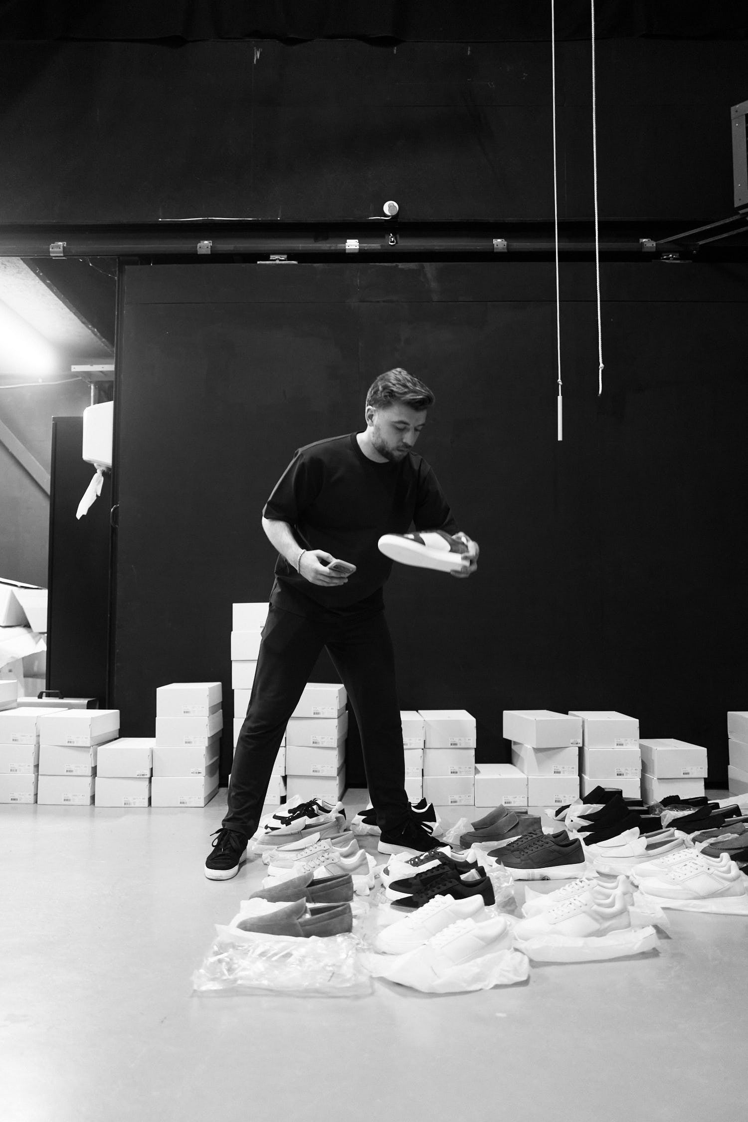 Checking an ETQ sneaker between rows of boxes